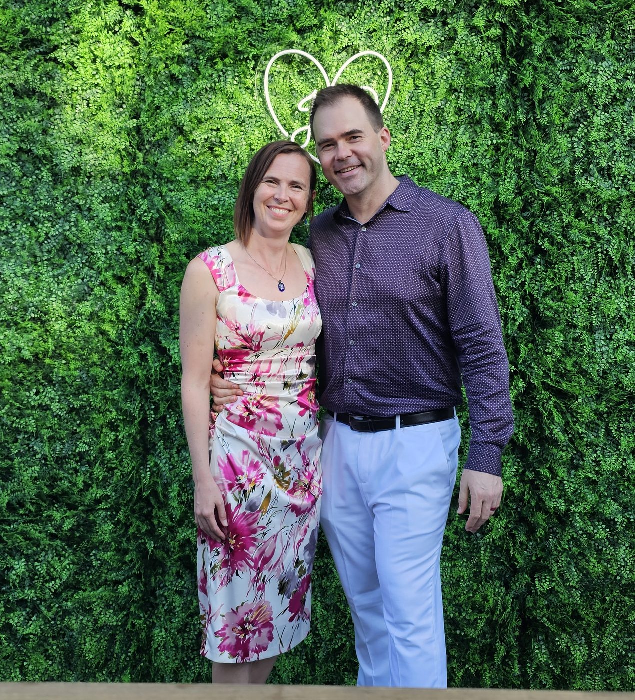 Cody and Kabe in front of a green wall